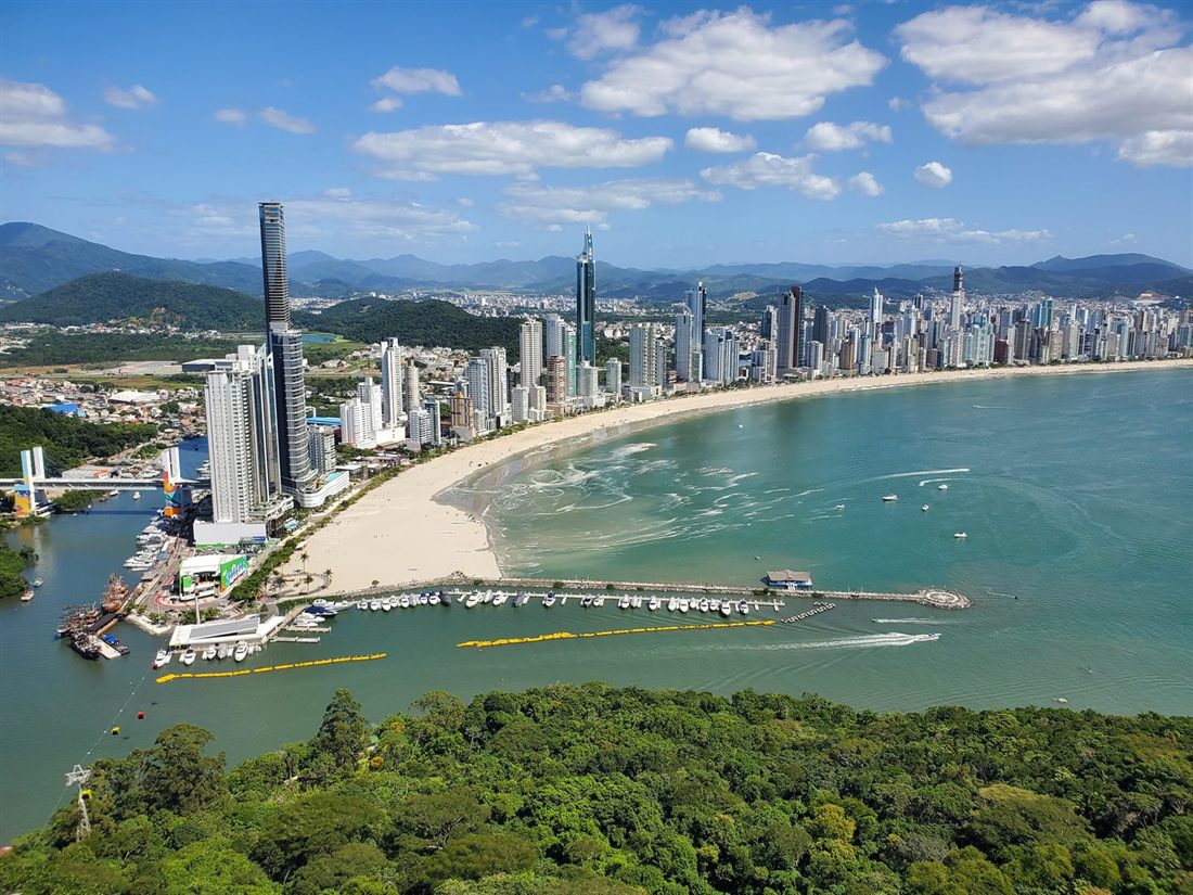Balneário Camboriú seen from Unipraias Park: the curving bay, the beach and the high-rises, with hills behind
