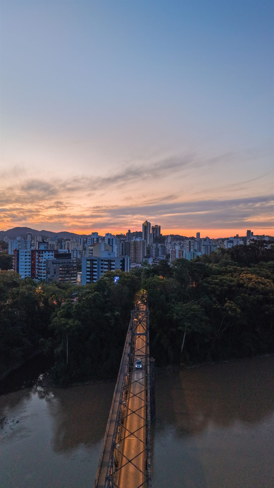 Aerial view at sunset of the Ponte de Ferro leading over the river into the center of Blumenau